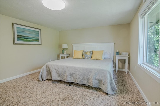 carpeted bedroom with baseboards