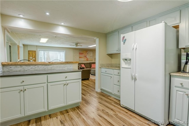 kitchen featuring ceiling fan, light wood-type flooring, white fridge with ice dispenser, white cabinetry, and recessed lighting