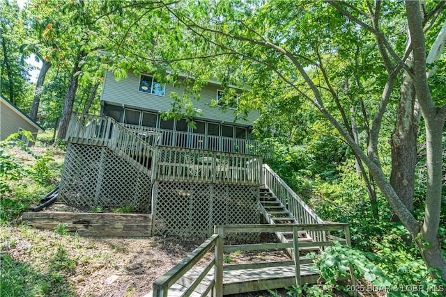 back of house featuring a deck and stairway