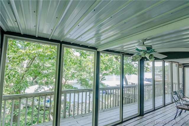 unfurnished sunroom with ceiling fan