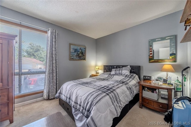 bedroom featuring a textured ceiling, carpet, and baseboards