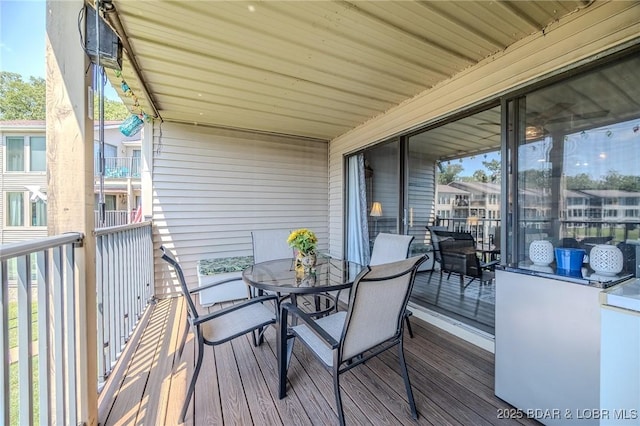 wooden terrace featuring outdoor dining space