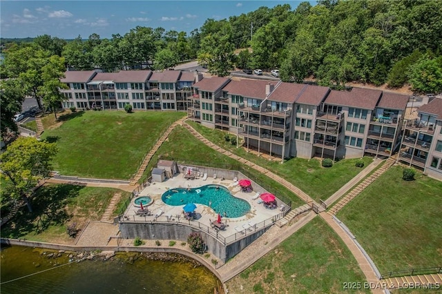 birds eye view of property with a water view