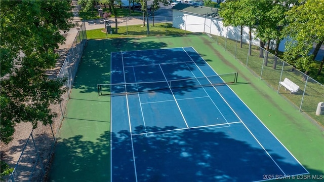 view of tennis court with fence