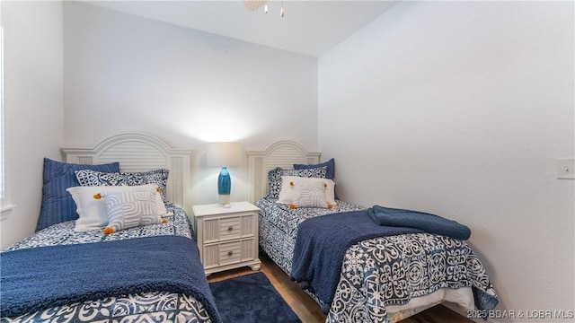 bedroom with a ceiling fan and wood finished floors