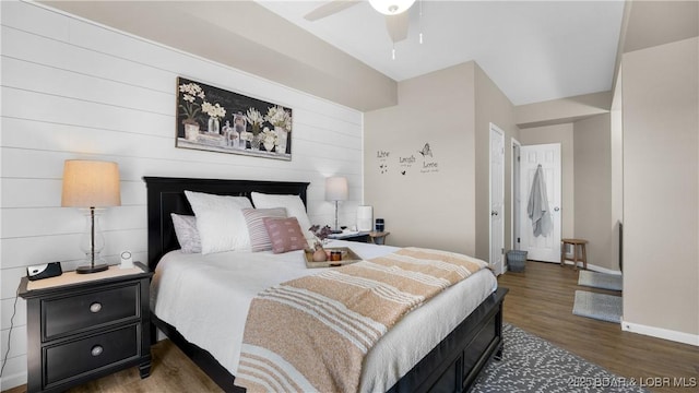 bedroom featuring ceiling fan, wood finished floors, and baseboards