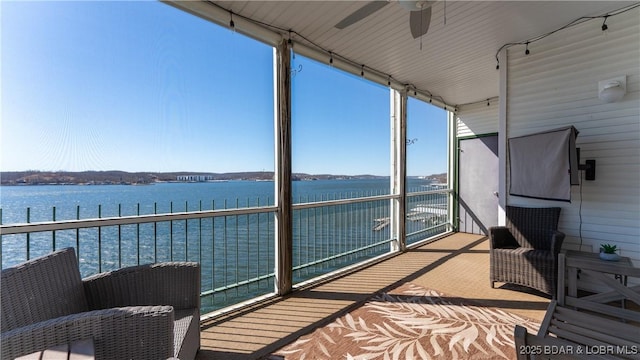 exterior space featuring a water view and ceiling fan