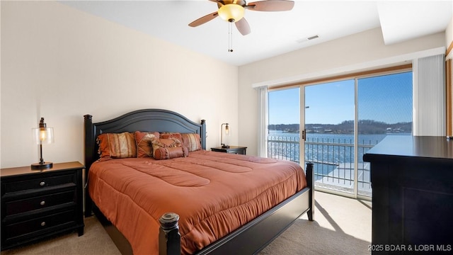 bedroom with visible vents, a ceiling fan, a water view, access to exterior, and carpet flooring