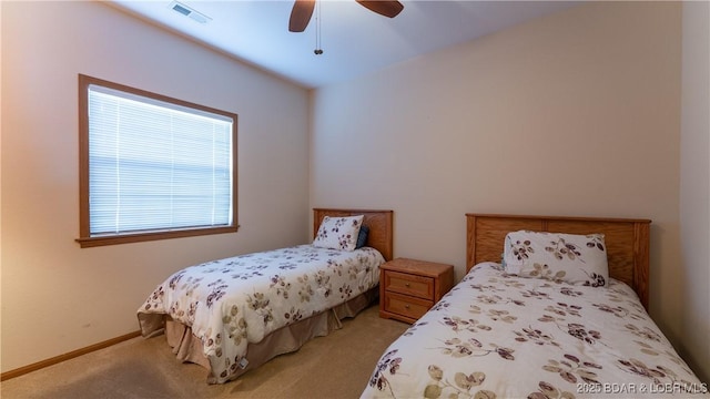 bedroom featuring visible vents, ceiling fan, light carpet, and baseboards