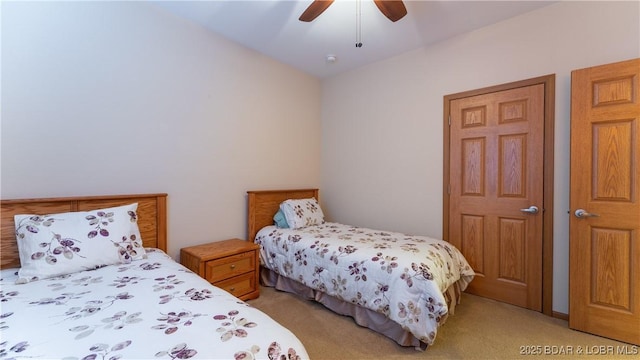 bedroom featuring a ceiling fan and light colored carpet