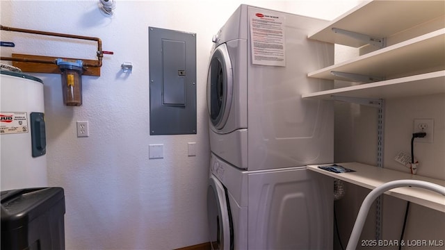 laundry area with water heater, laundry area, stacked washing maching and dryer, and electric panel