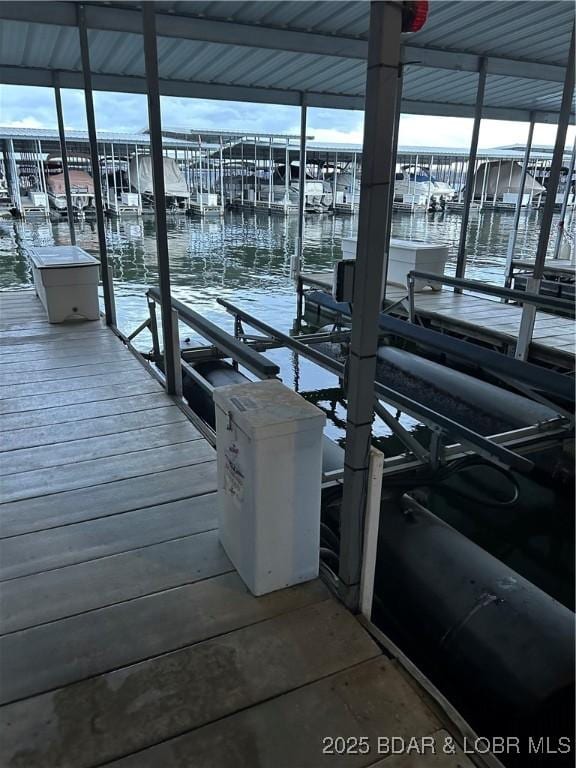 dock area with a water view and boat lift