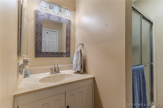 full bathroom featuring a stall shower and vanity