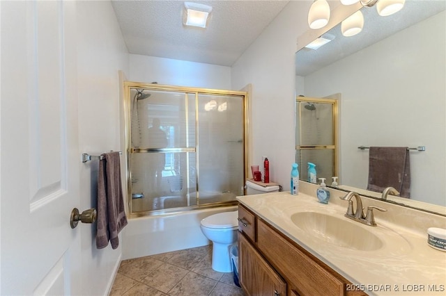 bathroom with toilet, combined bath / shower with glass door, a textured ceiling, vanity, and tile patterned flooring