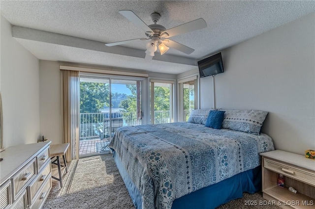 bedroom with a textured ceiling, multiple windows, carpet flooring, and access to exterior