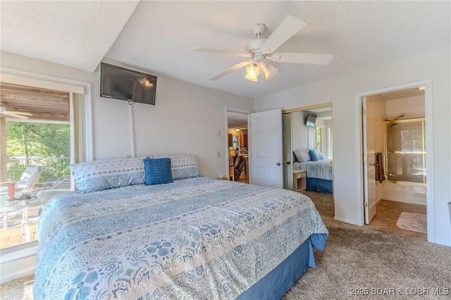 bedroom featuring ensuite bath, ceiling fan, carpet, a textured ceiling, and a closet