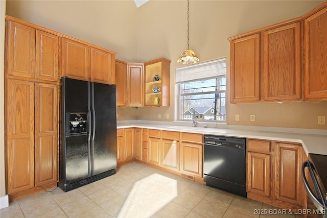 kitchen with open shelves, a towering ceiling, light countertops, black appliances, and decorative light fixtures