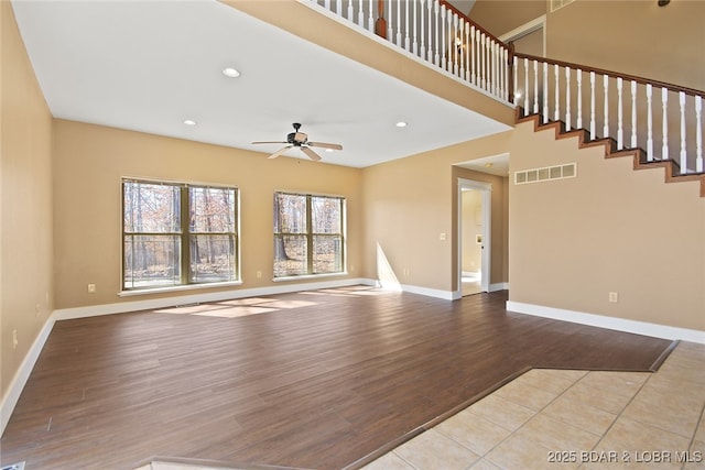 unfurnished living room with ceiling fan, recessed lighting, wood finished floors, visible vents, and baseboards