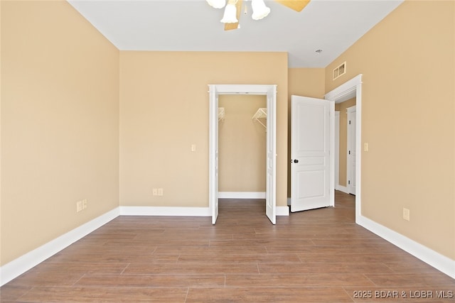 unfurnished bedroom featuring light wood-type flooring, baseboards, visible vents, and a closet