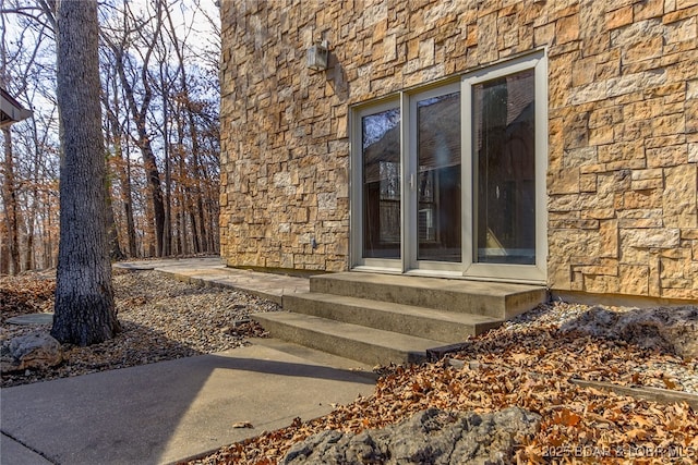 entrance to property with stone siding