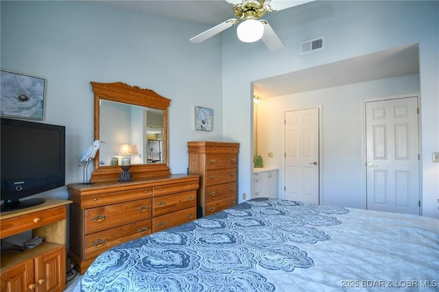 bedroom with a ceiling fan, visible vents, high vaulted ceiling, and connected bathroom