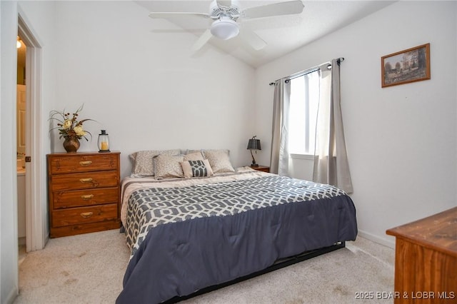 bedroom featuring ceiling fan, vaulted ceiling, and light carpet