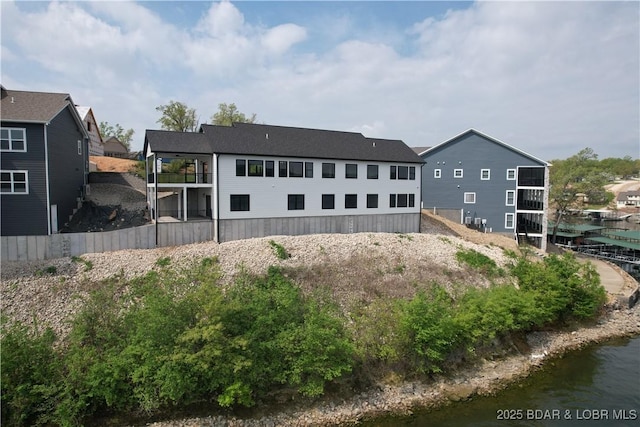 rear view of property with a water view