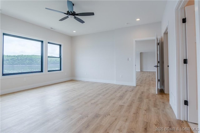 empty room with light wood finished floors, baseboards, a ceiling fan, and recessed lighting