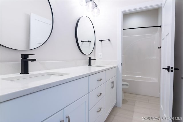 full bath with shower / washtub combination, a sink, toilet, and double vanity