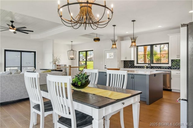325 Mission Bay Dr, Camdenton, MO 65020 - dining space with ceiling fan with notable chandelier, recessed lighting, and wood finished floors