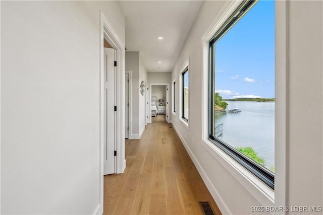 325 Mission Bay Dr, Camdenton, MO 65020 - hallway with visible vents, recessed lighting, light wood-style flooring, a water view, and baseboards