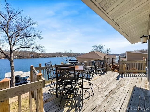 wooden deck featuring a dock and a water view