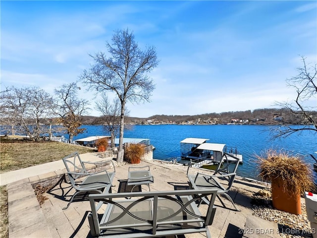 view of patio featuring a boat dock and a water view