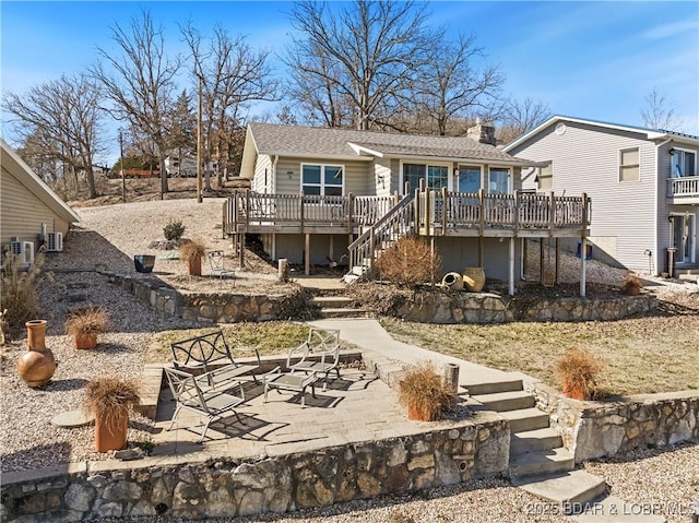 back of property featuring stairs, a patio area, and a wooden deck