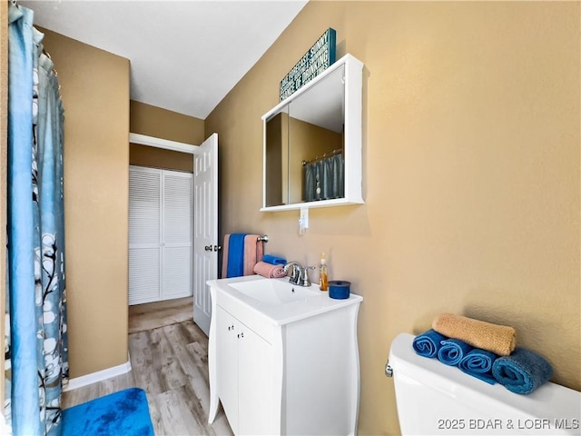 full bathroom featuring vanity, toilet, and wood finished floors