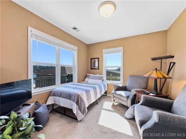 bedroom with visible vents and carpet flooring