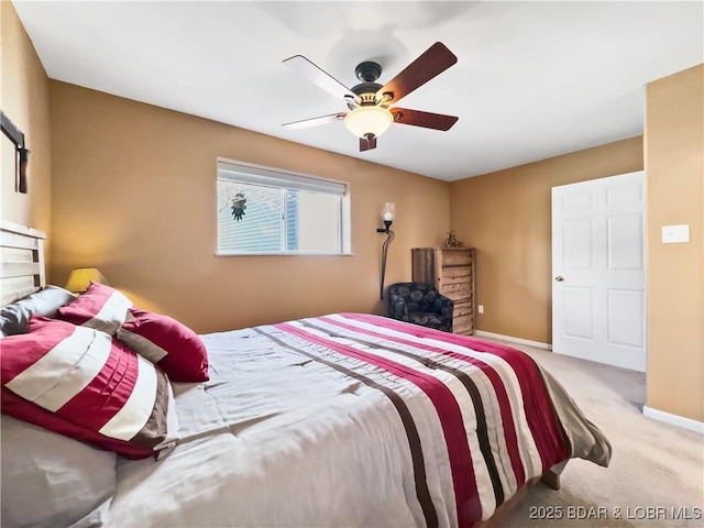 carpeted bedroom featuring ceiling fan and baseboards