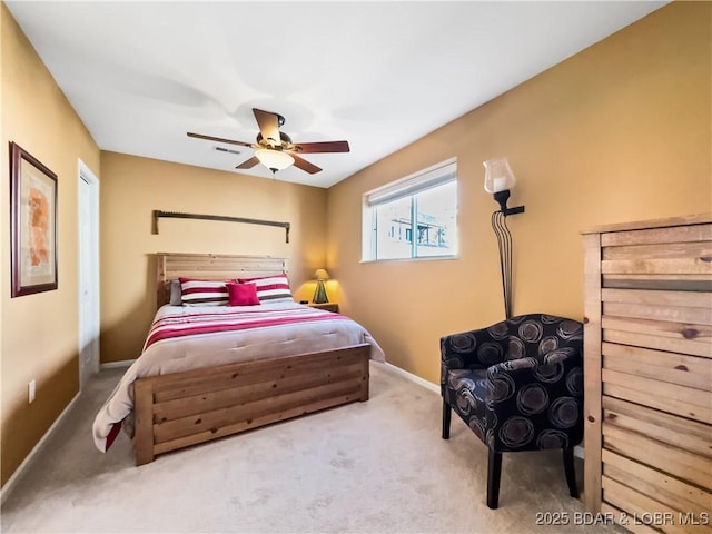 bedroom featuring ceiling fan, carpet floors, visible vents, and baseboards