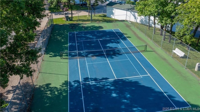 view of tennis court featuring fence