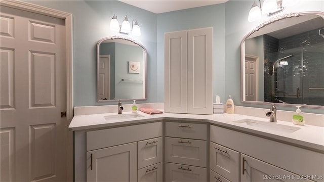 bathroom featuring a stall shower, a sink, and double vanity