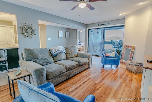 living room with ceiling fan and wood finished floors