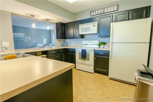 kitchen with pendant lighting, white appliances, light countertops, and a sink