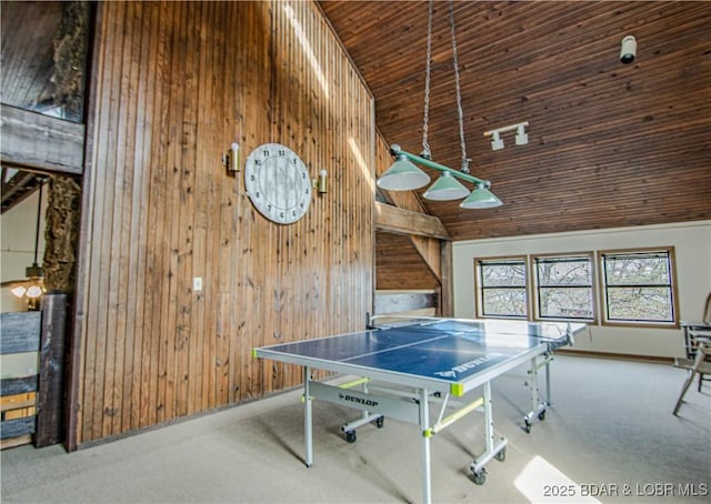 recreation room featuring carpet floors, wooden ceiling, high vaulted ceiling, and wooden walls