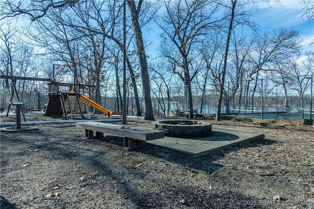 view of yard with a fire pit and playground community