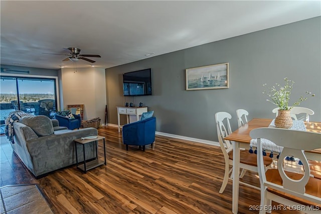 living area featuring ceiling fan, baseboards, and wood finished floors