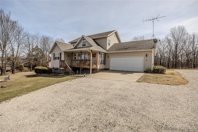 view of front facade featuring a front yard, a garage, covered porch, and driveway