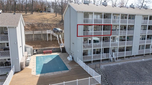 exterior space with fence and a community pool