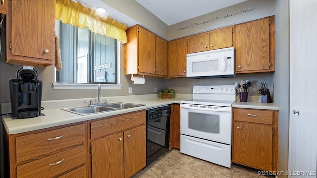 kitchen with brown cabinetry, white appliances, light countertops, and a sink