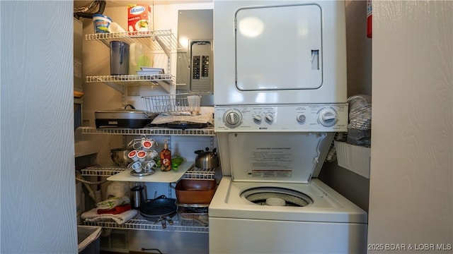 washroom featuring stacked washer and dryer and laundry area