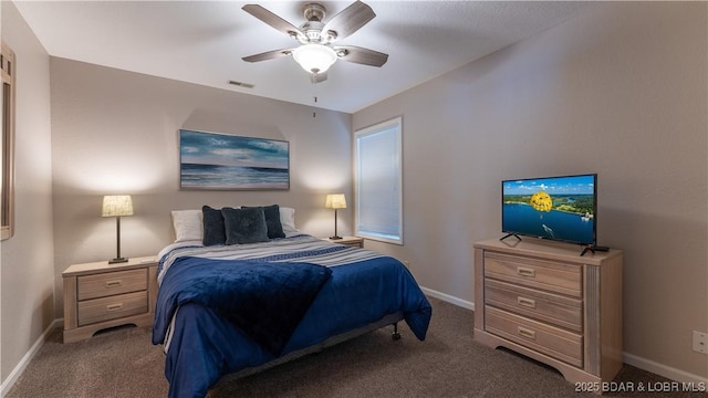 carpeted bedroom featuring visible vents, ceiling fan, and baseboards